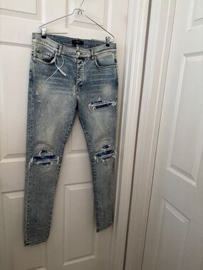 AMIRI Light Blue Distressed Skinny Jeans with Patch Details